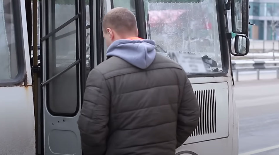 sad person getting on bus